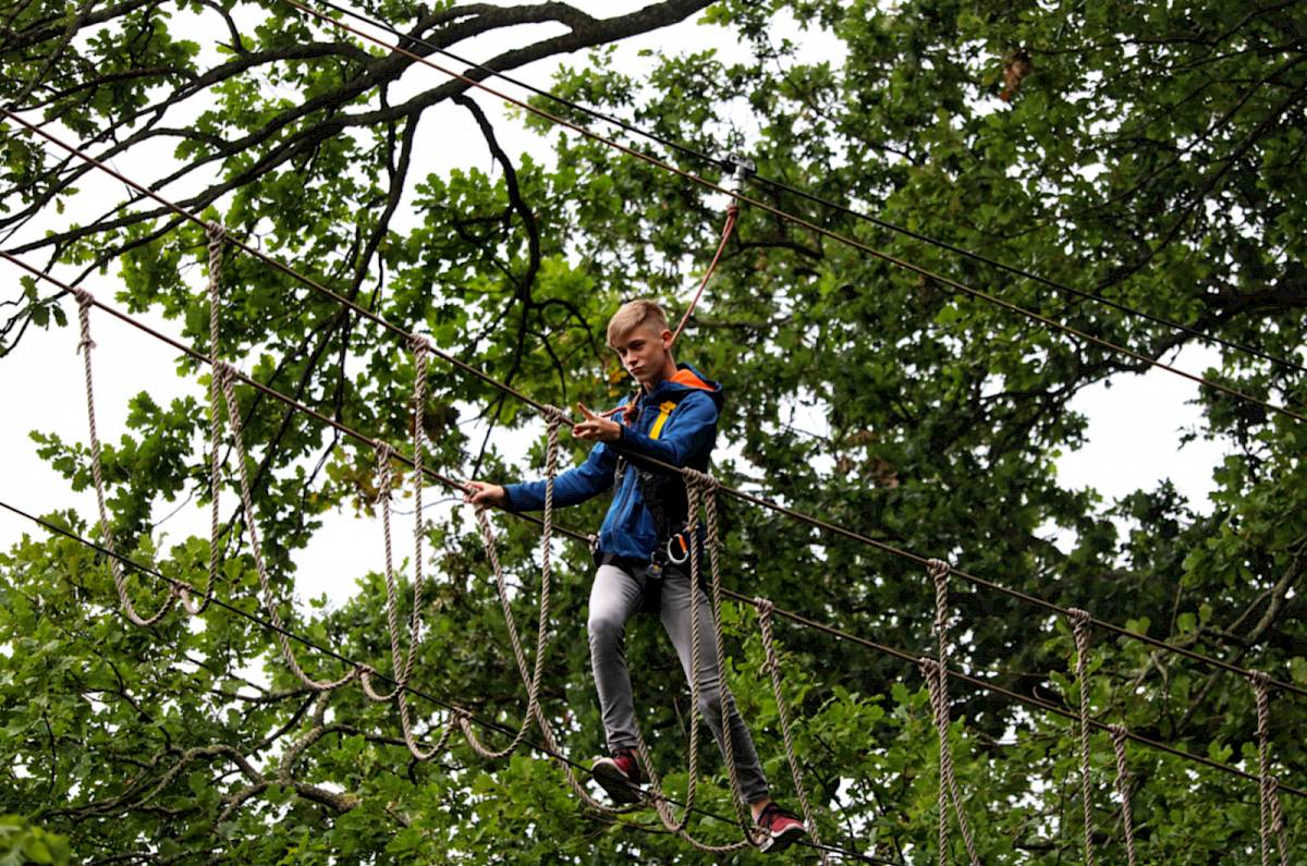 ISSFT student negotiating a treetop walkbridge