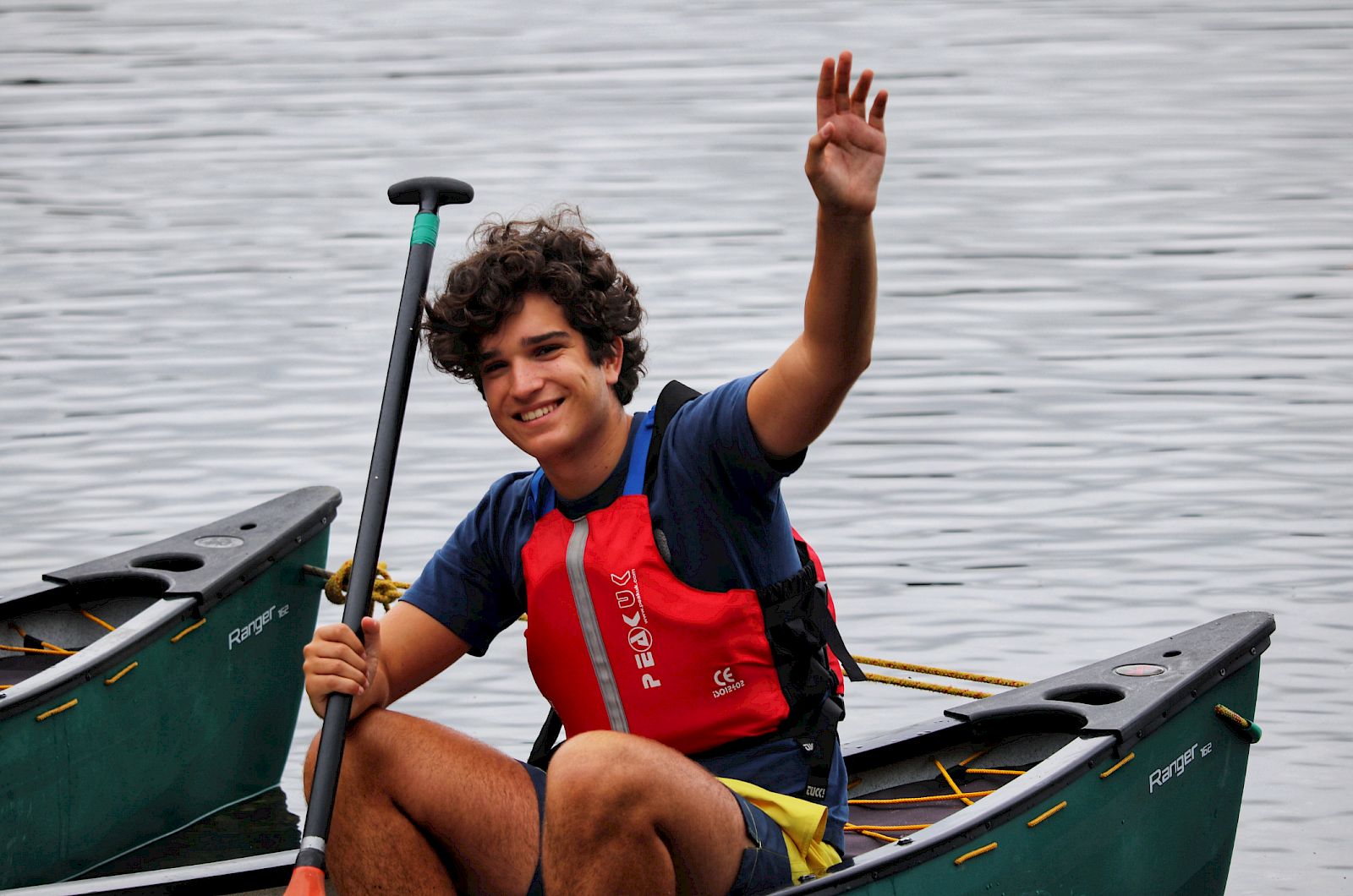 ISSFT student waving from a canoe