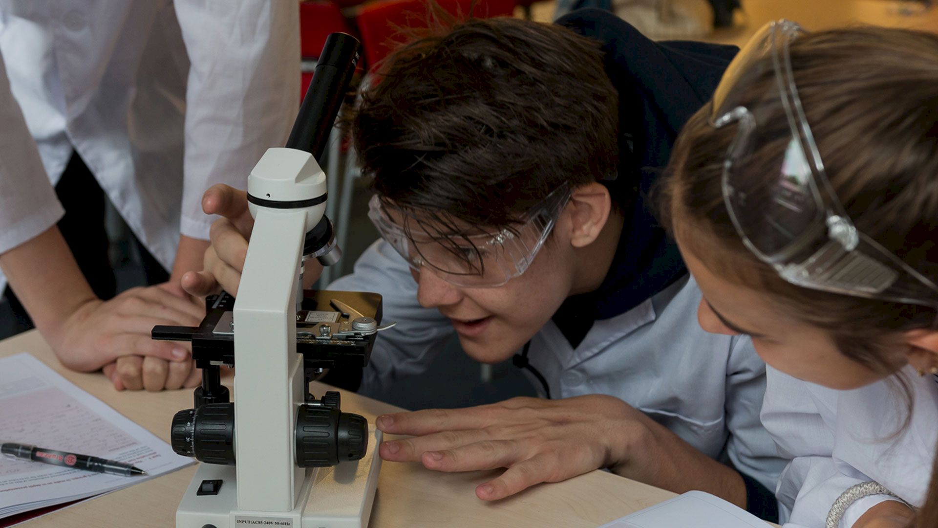 ISSFT student looking through a microscope