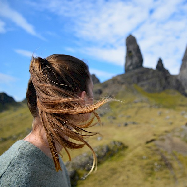 Girl looking up towards a mountain top