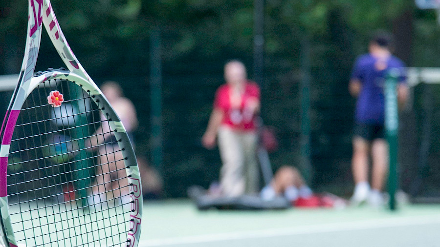 tennis summer camp for teenagers teen leaning on tennis racket