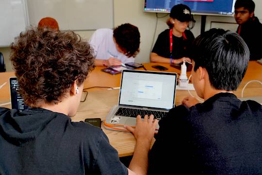Students exploring artificial intelligence and coding concepts in a modern classroom, symbolising how AI is transforming education and learning at ISSFT.