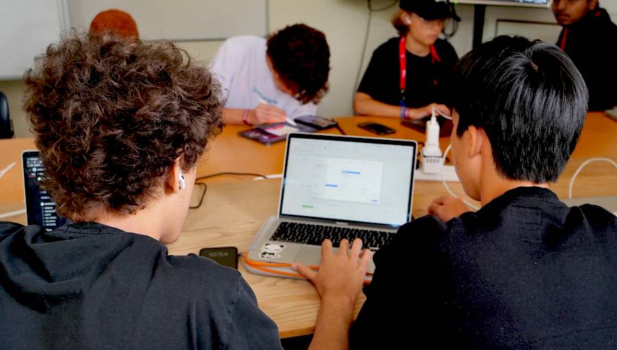 Students exploring artificial intelligence and coding concepts in a modern classroom, symbolising how AI is transforming education and learning at ISSFT.