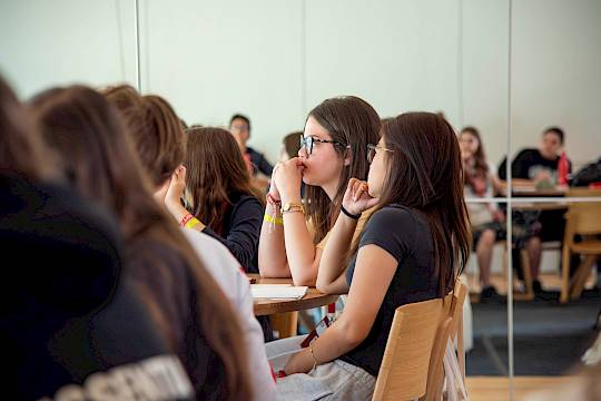 IB students revising together for their November exams at ISSFT, with notebooks and laptops open in a bright study space.