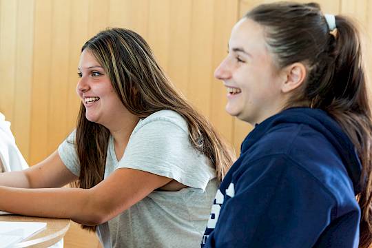 International teen students working together in a classroom during a world languages lesson