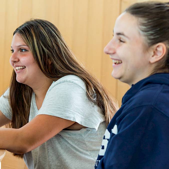 International teen students working together in a classroom during a world languages lesson