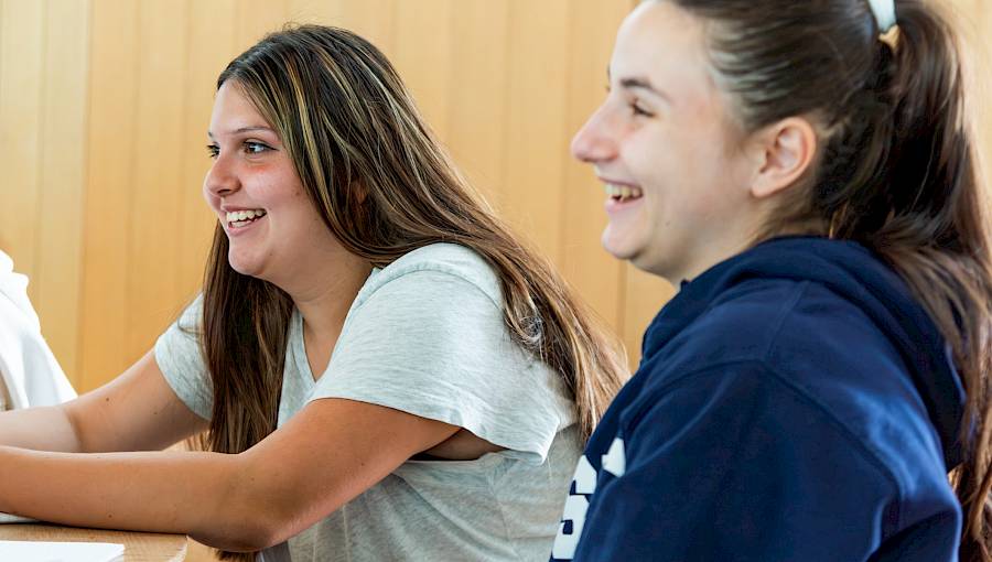 International teen students working together in a classroom during a world languages lesson