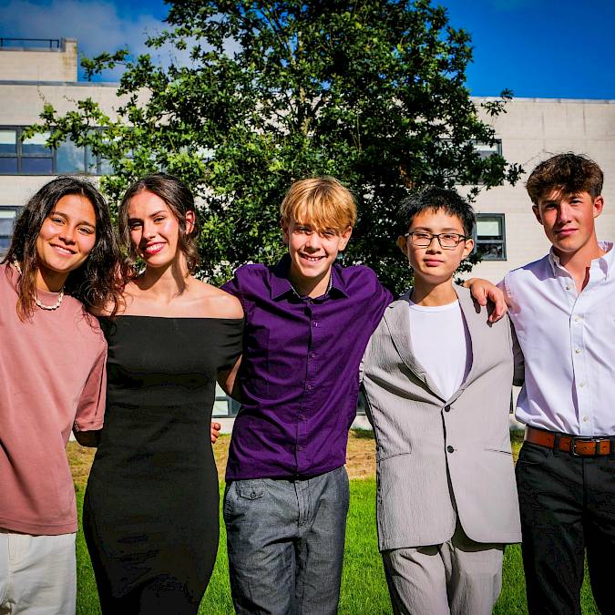 Teenagers attending a university-style academic class at an international summer school