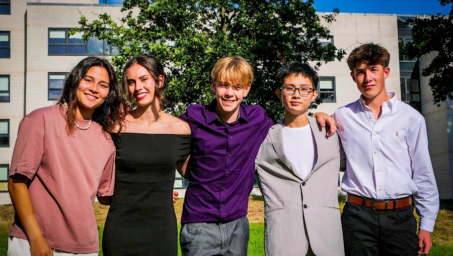 Teenagers attending a university-style academic class at an international summer school
